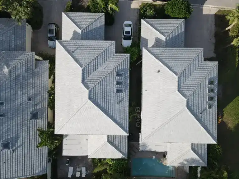 Overhead view of gray tile roofs and driveways on neighboring homes in Waters Edge, Boca Raton