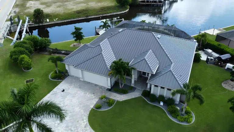 Gray standing seam metal roof on a waterfront home