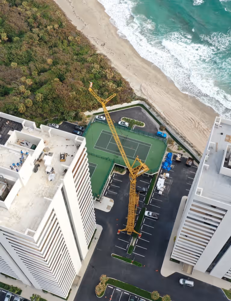 Flat roof work under way on an oceanfront condo tower, seen from above
