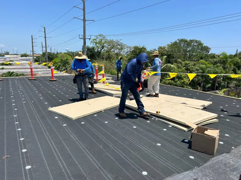 Insulation board going down over the base sheet on a flat roof