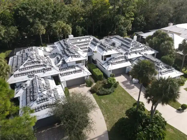 Tile roof installation on a large home beside trees in Sand Drift, West Palm Beach