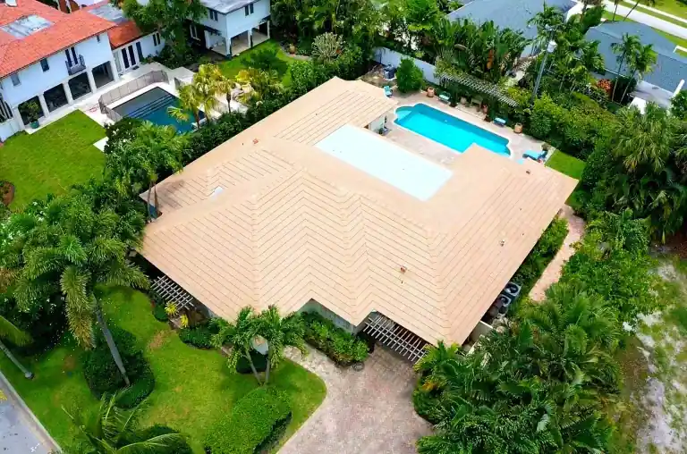Pale tile roof on a waterfront house with a backyard swimming pool in West Palm Beach, photographed June 2025